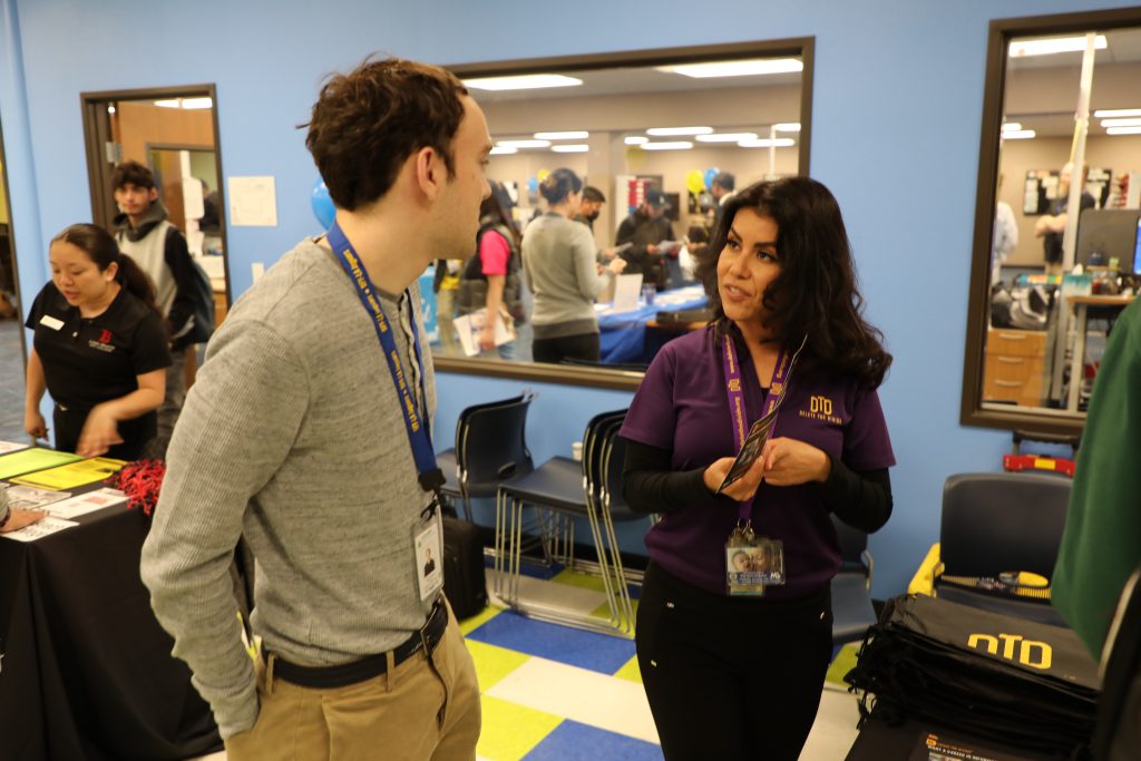 Intern talking to patron