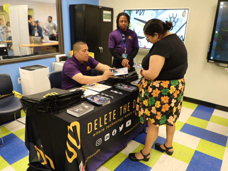 DTD staff handing a flyer to someone