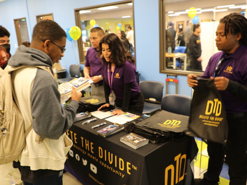 DTD staff standing behind booth helping students