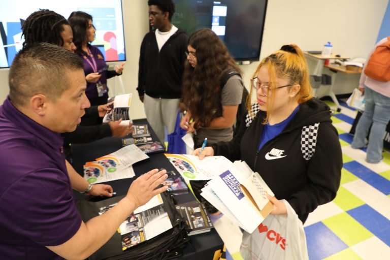 Intern explaining handout to youth