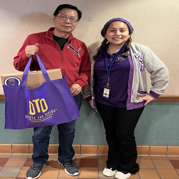 DTD intern standing next to a person holding a bag with a laptop