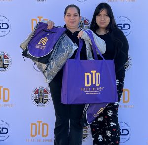 Mother and daughter posing with DTD merch