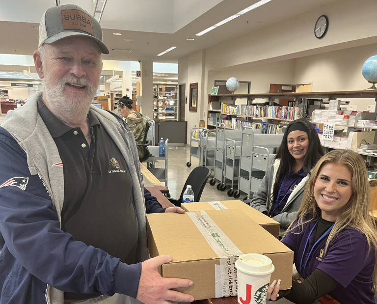 veteran handing out laptop