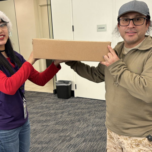 Intern holding a Laptop with a participant