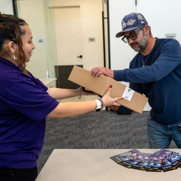 Intern handing out Laptop to Veteran