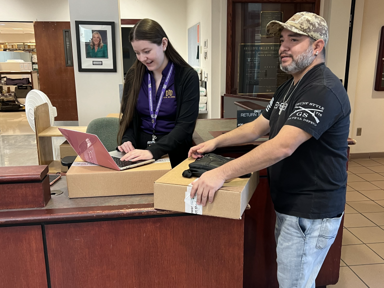 Interns handing out laptops