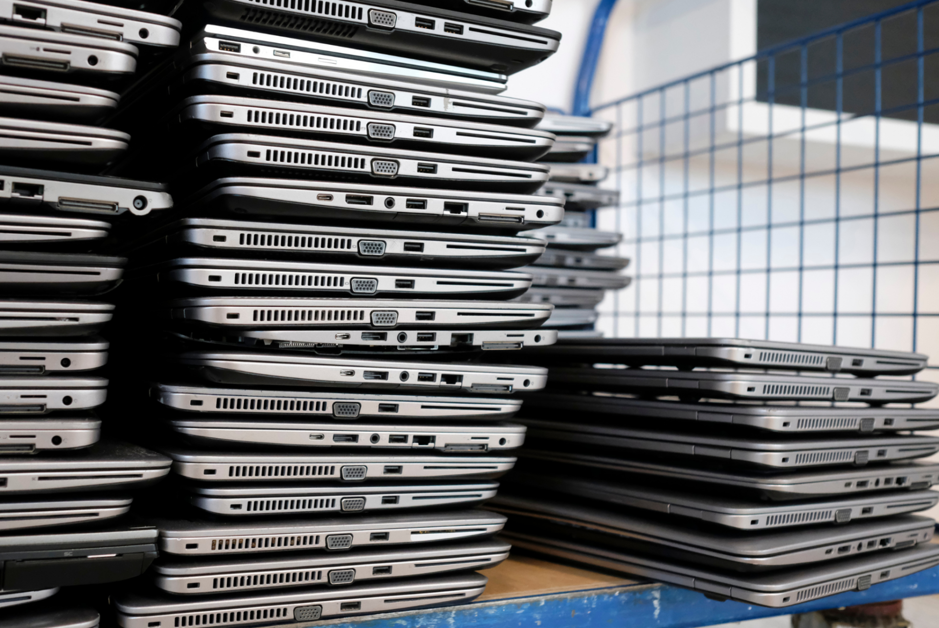 multiple stacks of laptops on top of each other