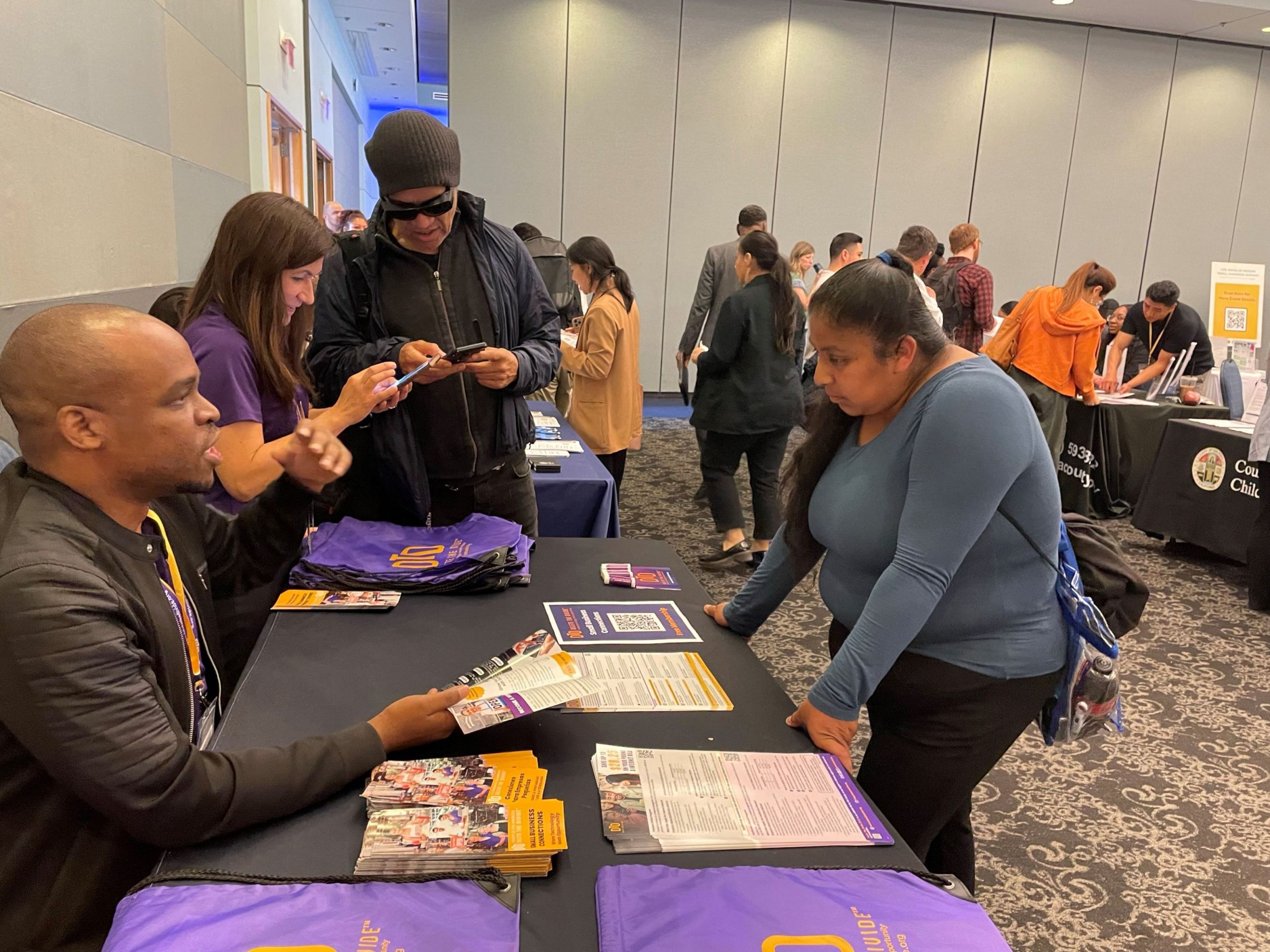 Delete The Divide member speaking with patron