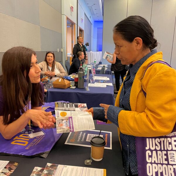 Delete The Divide member speaking with patron