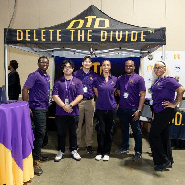Group photo of the DTD staff standing Infront of their booth at the Women's Health Expo