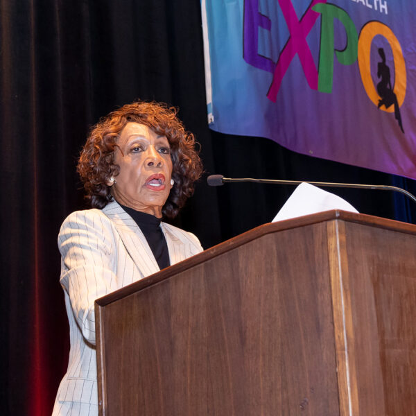 Female speaker at the podium for the Women's Health Expo