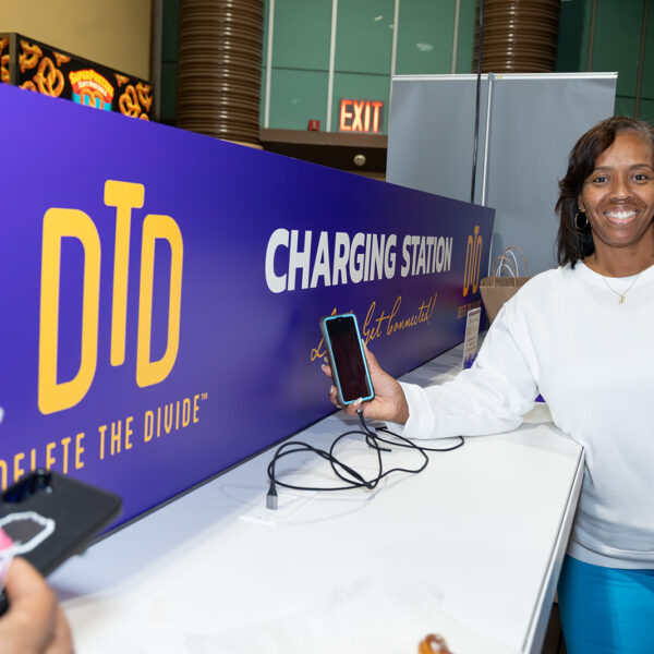 DTD's charging station helping charge a happy patron's phone