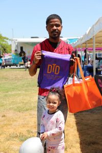 Father and daughter holding dtd bag