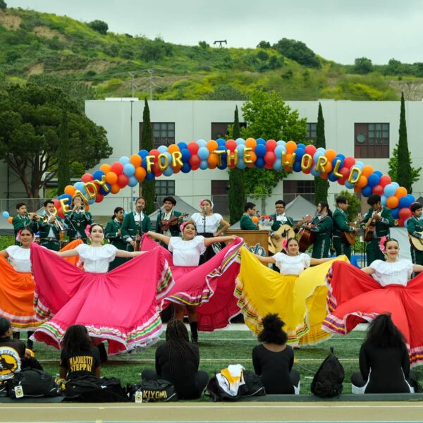 students singing, playing instruments, and dancing