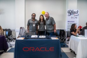 3 recruiter standing with table