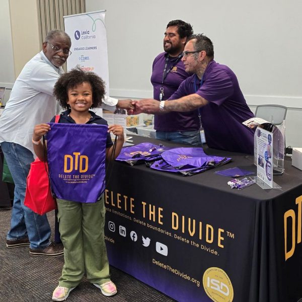 person smiling and receiving laptop at bridge la