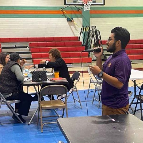 DTD intern talking with microphone to participants