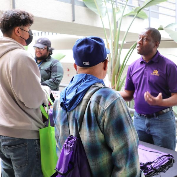 DTD staff and intern talking to two people