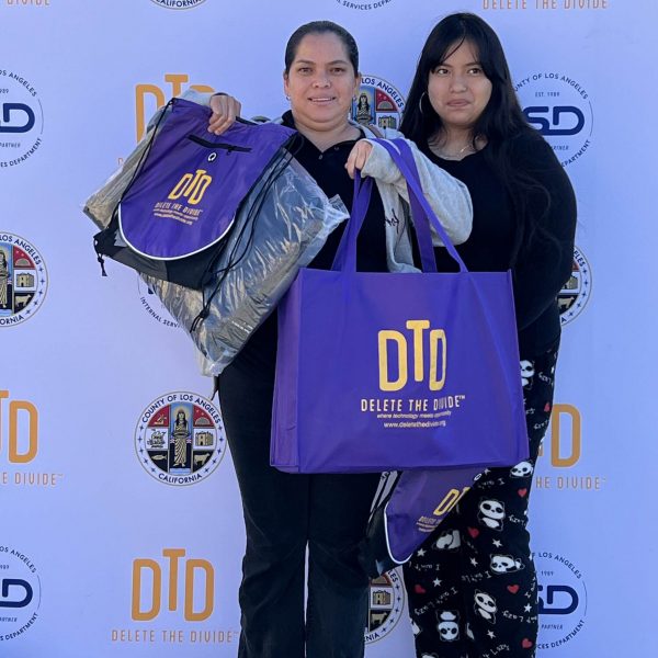 two girls holding up DTD bags