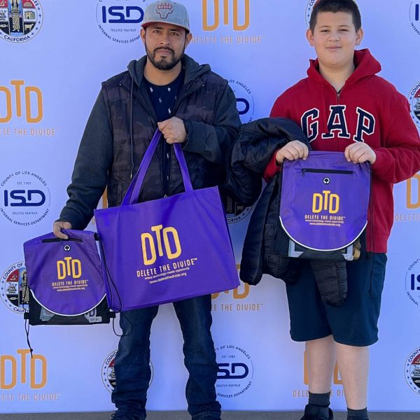 a father and son holding DTD bags