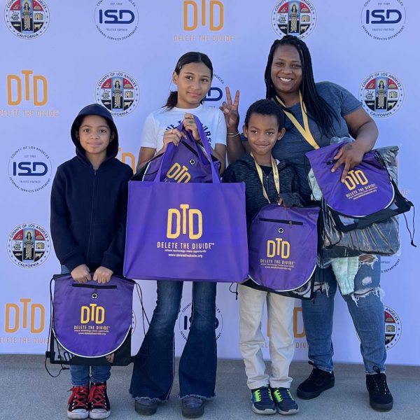 a family of four holding DTD bags