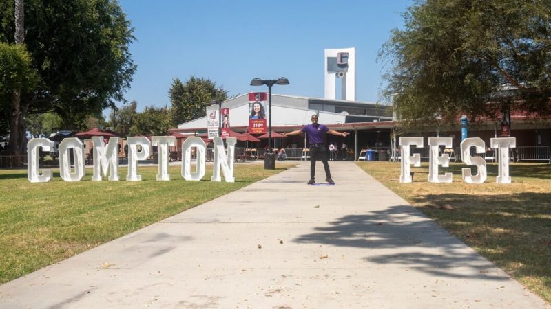 DTD staff standing between two big letterings, "COMPTON" and "FEST"