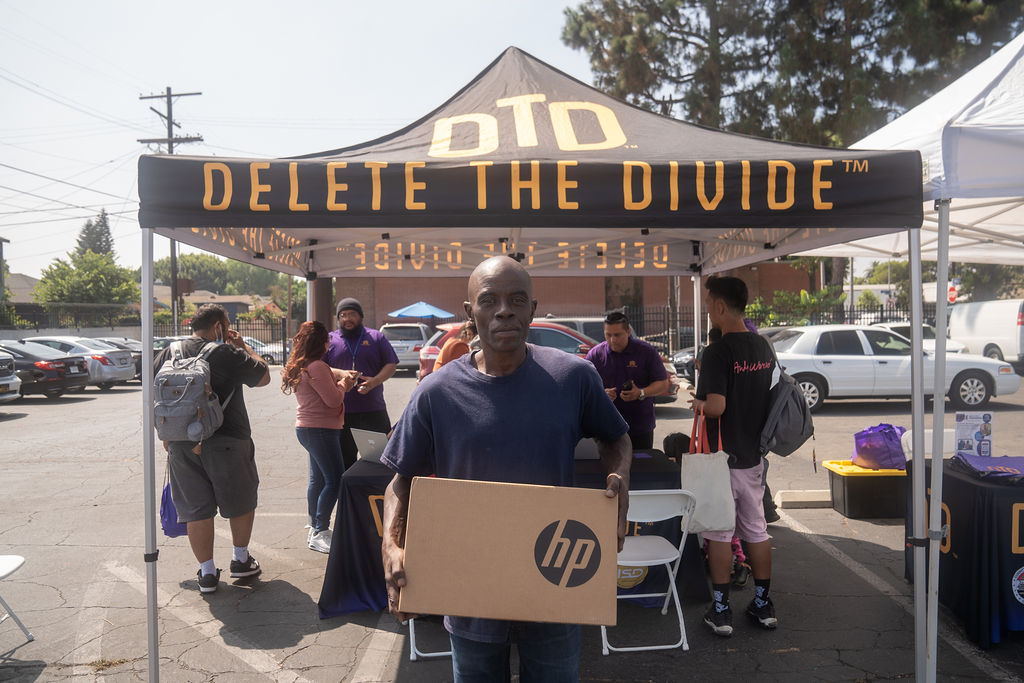 a man holding a HP laptop box