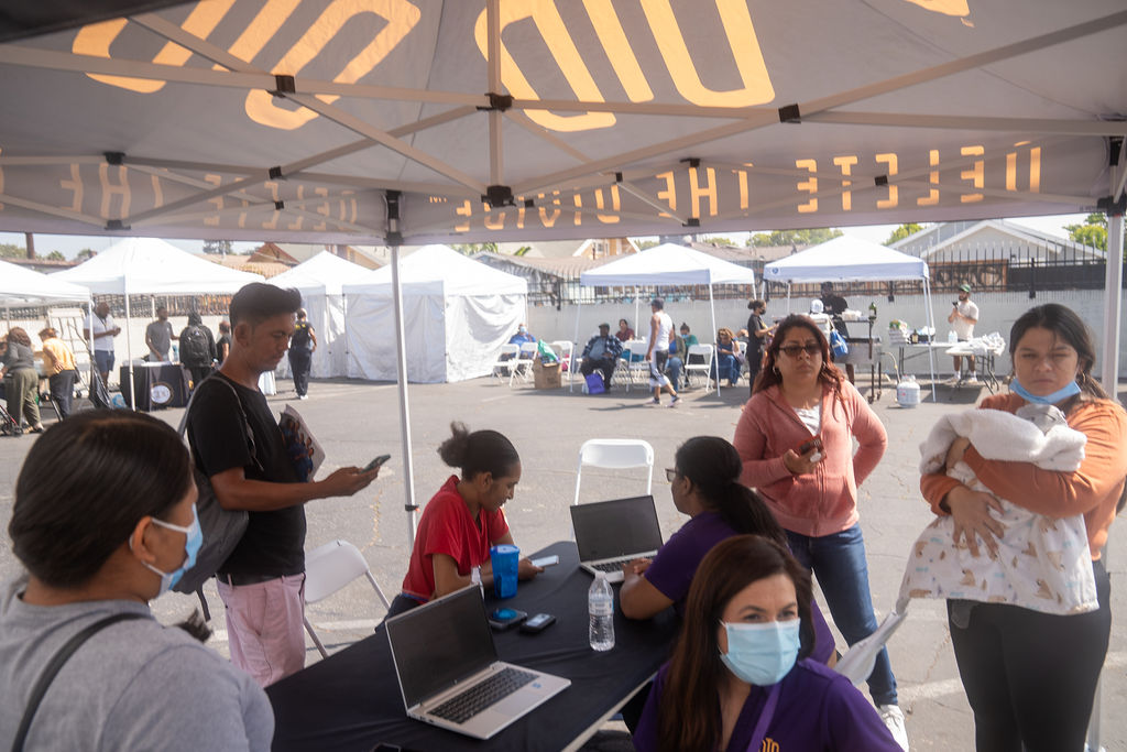 DTD staff sitting with their computers as people gather around