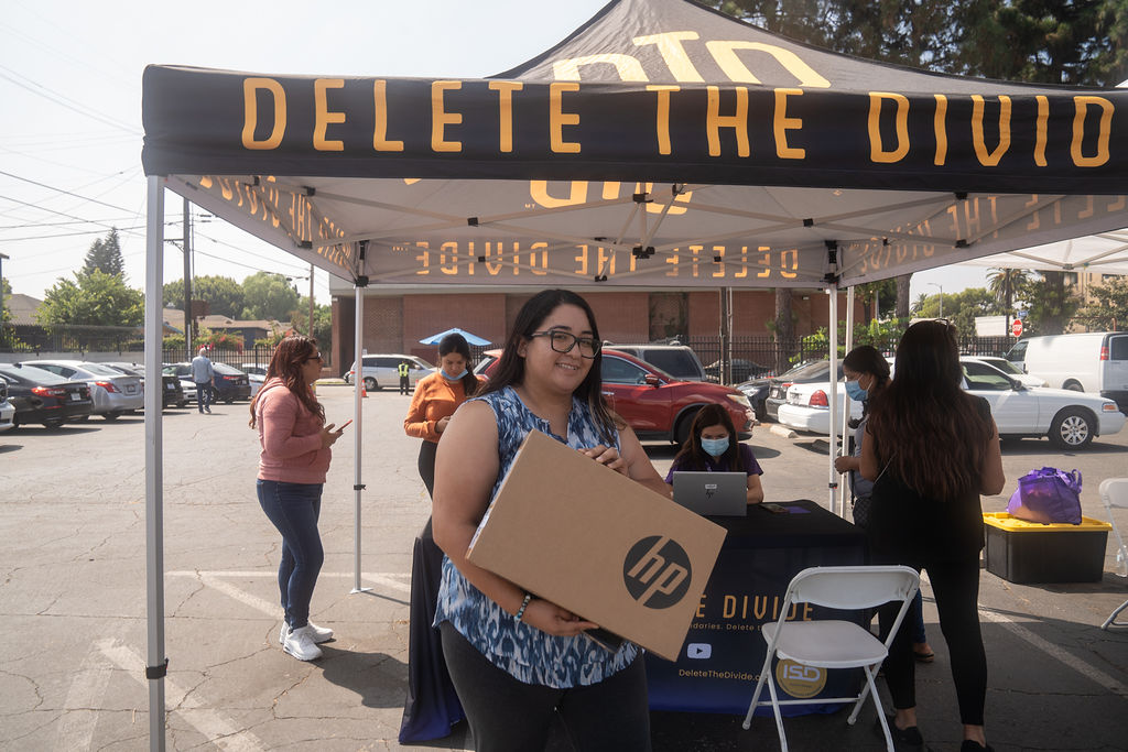 a woman holding an HP laptop box