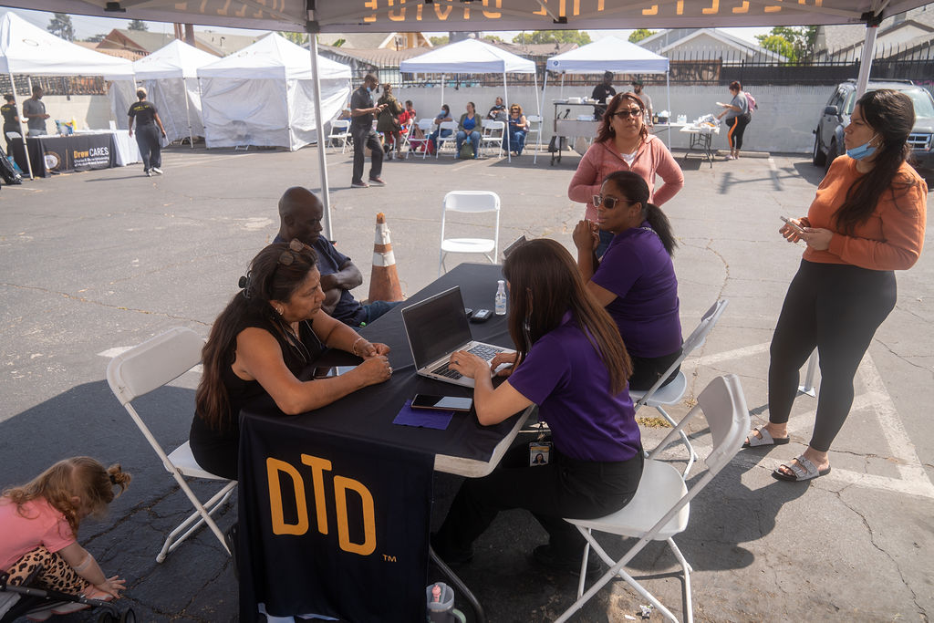 DTD staff on their laptops trying to help people