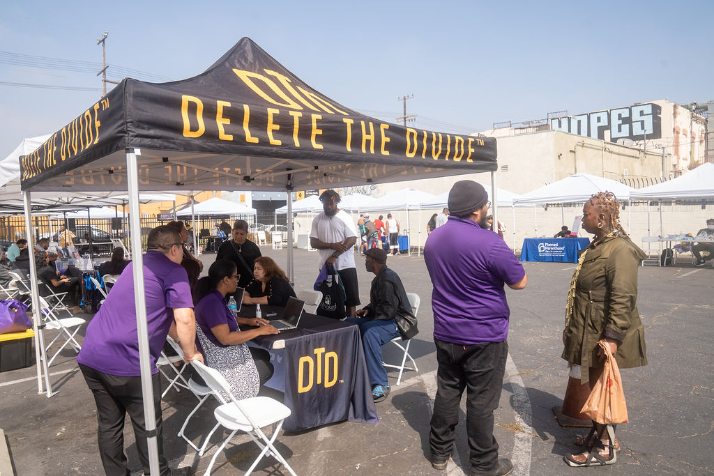DTD staff both sitting and standing while helping out community members
