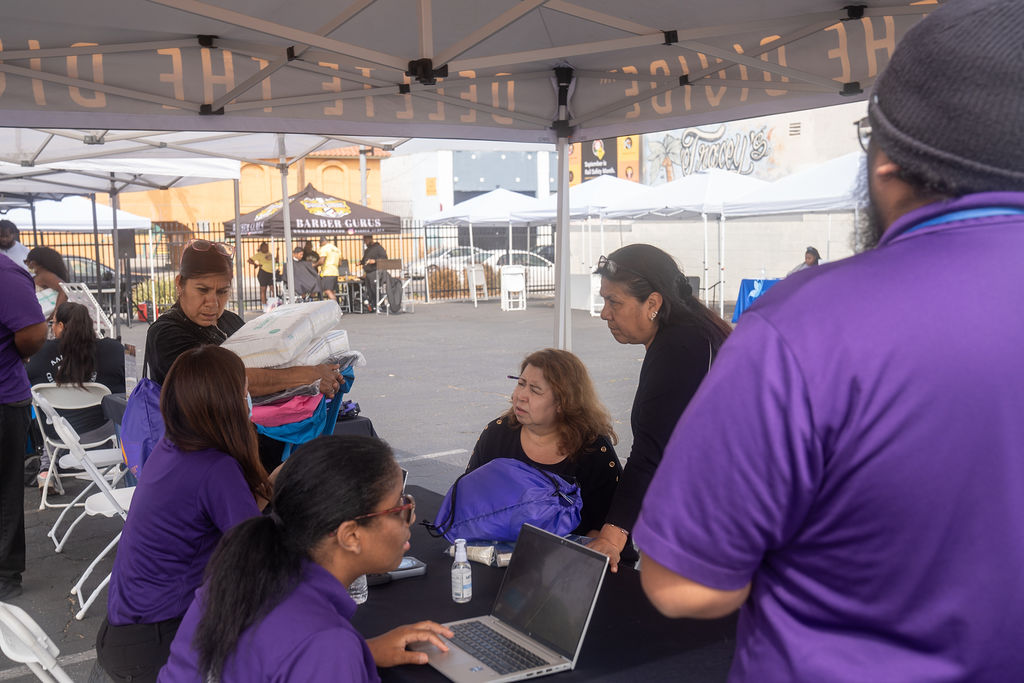 a group of interns helping three women