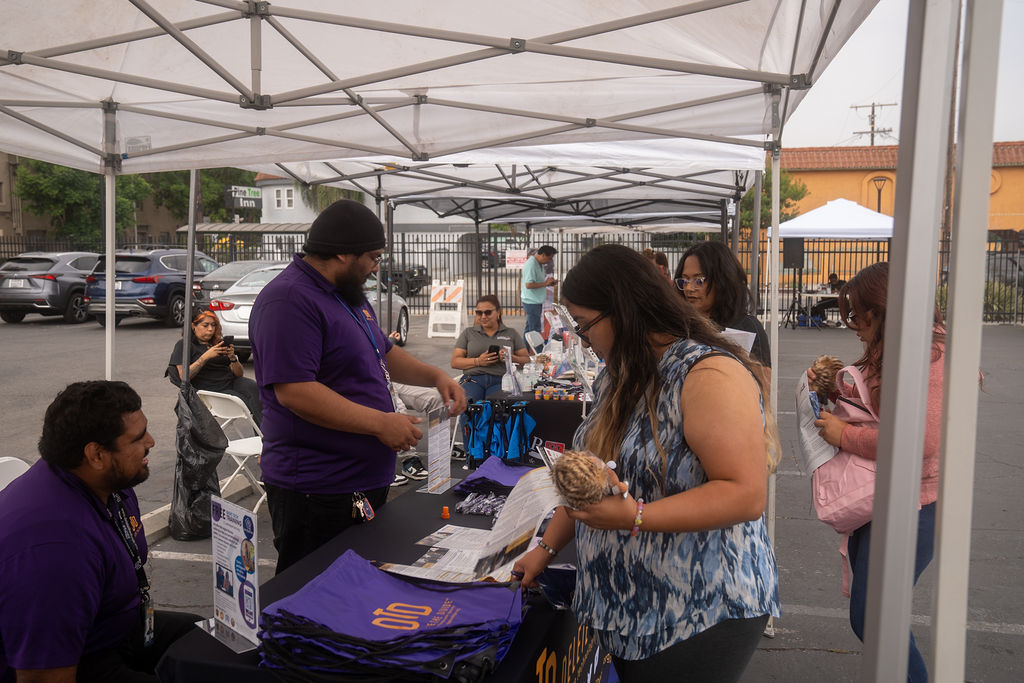 DTD interns passing out flyers and bags to people walking by