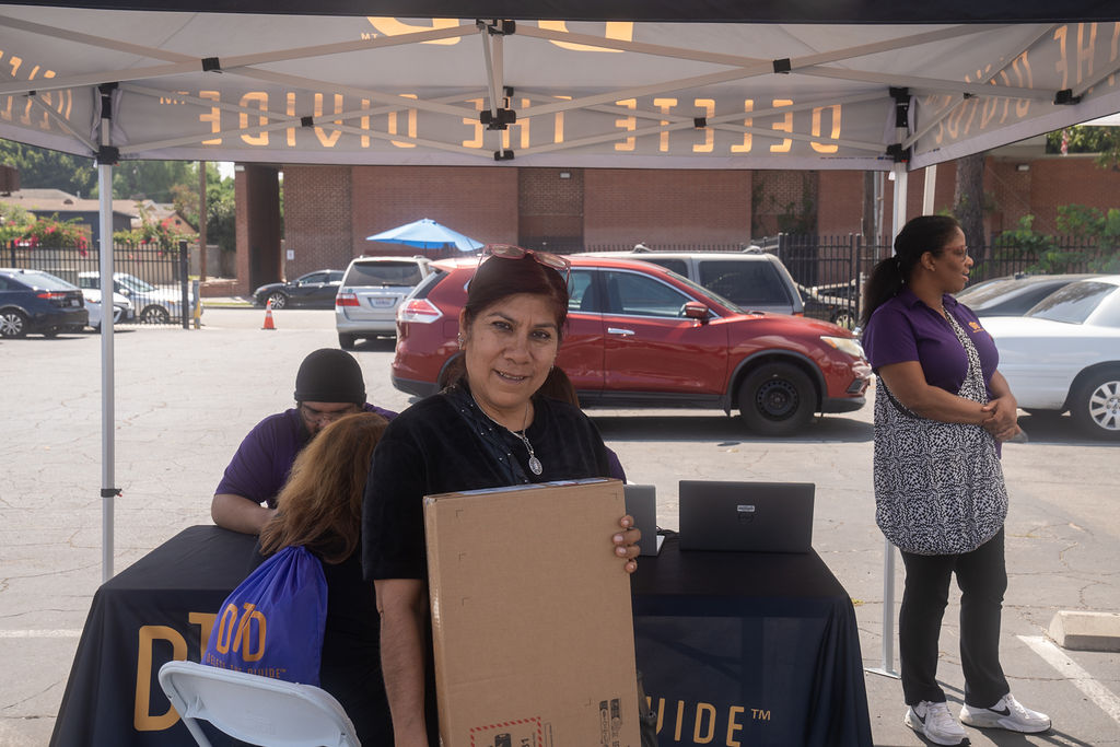 a woman holding a HP laptop box
