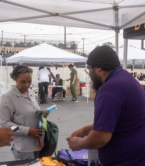 DTD staff giving DTD merch to people walking by