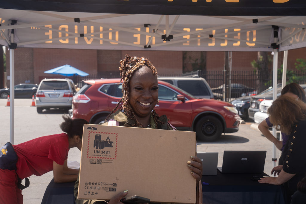 a woman holding a laptop box