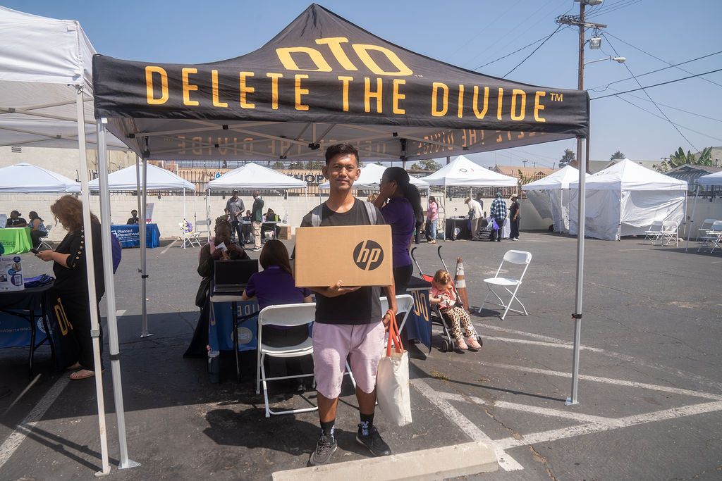 a man holding a HP laptop box