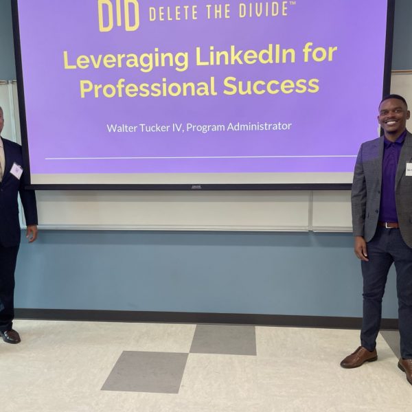 two DTD staff standing in front of a projected presentation saying, "Leveraging LinkedIn for Professional Success"