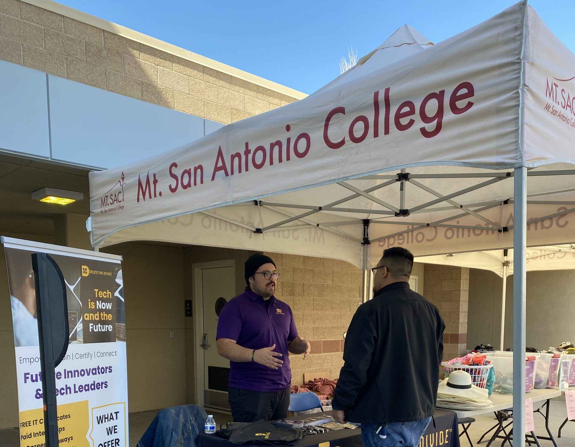 DTD intern talking to someone under a Mt. SAC canopy