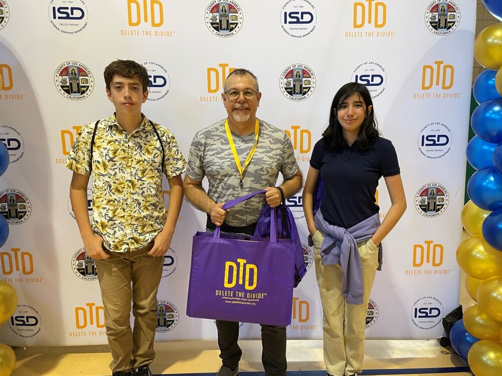 a family holding a bag with a laptop