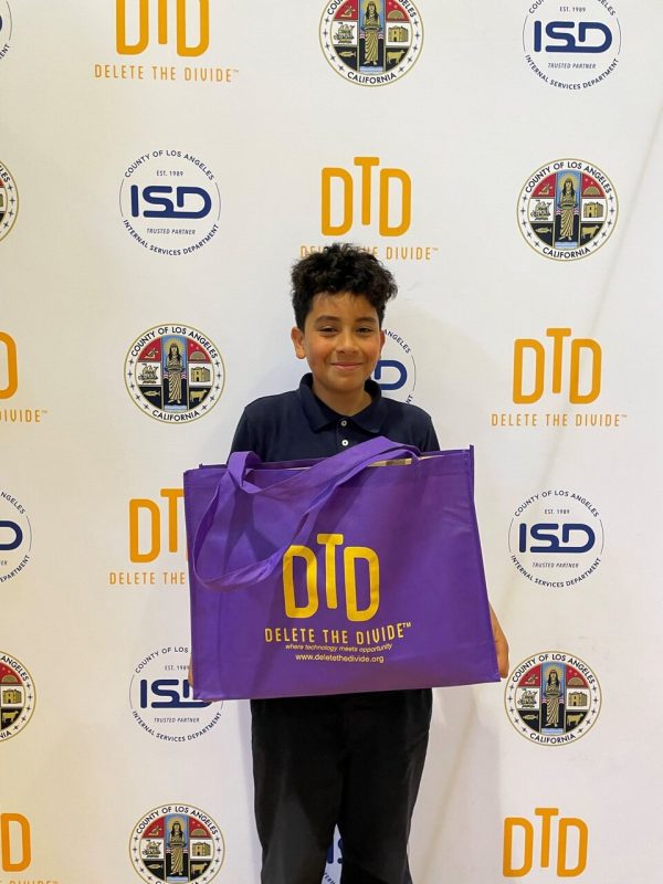 a boy holding up a DTD bag with a laptop