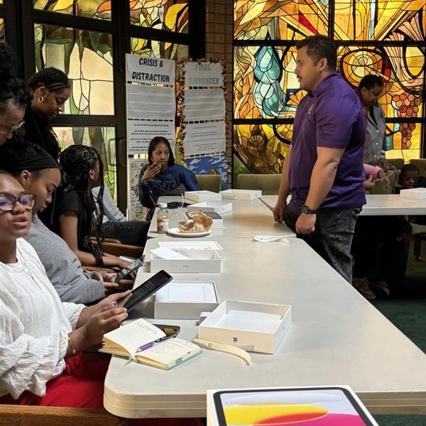 DTD staff assisting students with iPad distribution and