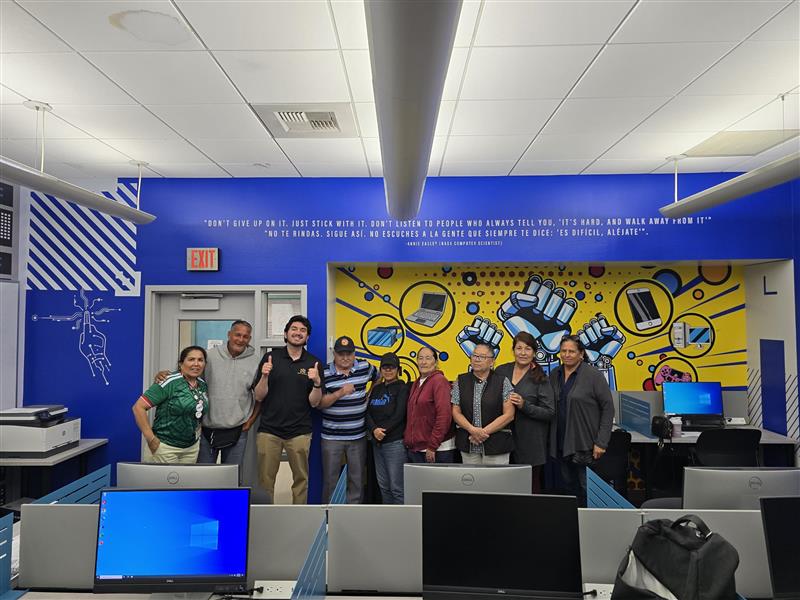group standing behind computers